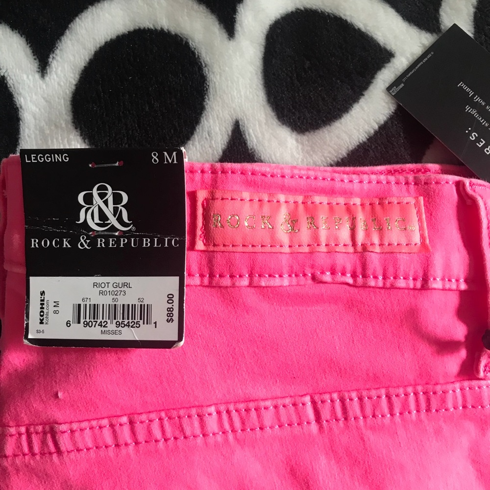 Pink jeans with gold flat studs on back pockets